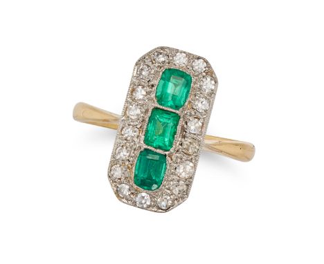 AN EMERALD AND DIAMOND DRESS RING in yellow gold, the octagonal face set with three cushion cut emeralds in a border of singl