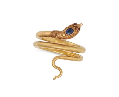 AN ANTIQUE SAPPHIRE AND GARNET SNAKE RING in yellow gold, designed as a coiled snake, the head set with an oval cut sapphires