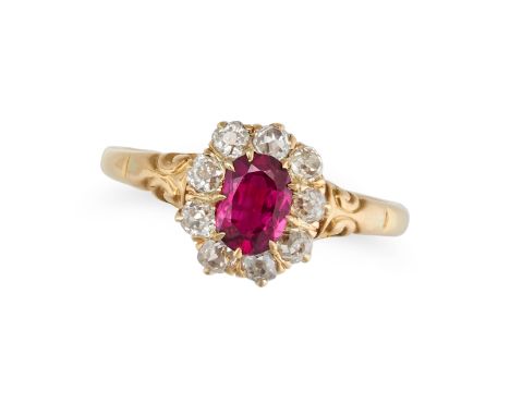 A RUBY AND DIAMOND CLUSTER RING set with an oval cut ruby of approximately 0.56 carats in a cluster of old cut diamonds, stam