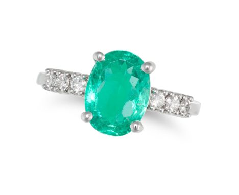 A COLOMBIAN EMERALD AND DIAMOND RING set with an oval cut emerald of 2.15 carats, the shoulders accented by trios of round cu