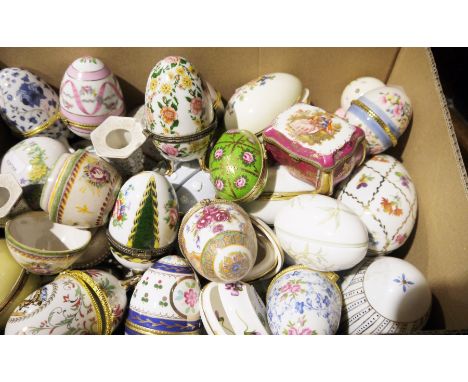 Collection of ceramic trinket boxes, mainly egg shaped and a pair of ceramic candlesticks