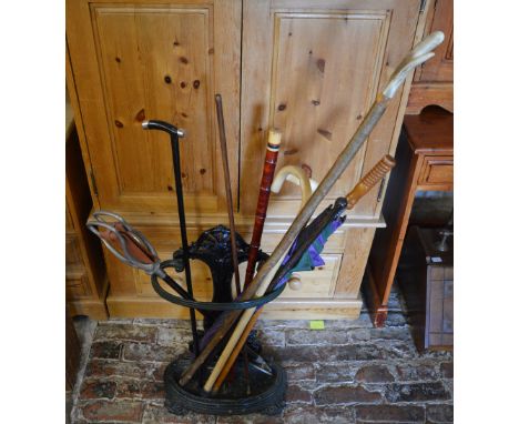 Umbrella stand with walking sticks, umbrellas and a shooting stick