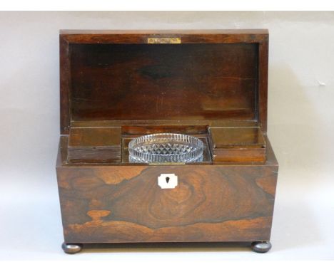 A Georgian rosewood tea caddy, of sarcophagus form, with glass mixing bowl