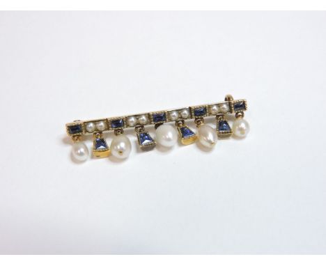 An Art Deco gold sapphire and pearl fringe bar brooch, with pairs of split pearls between French cut sapphires, with a fringe