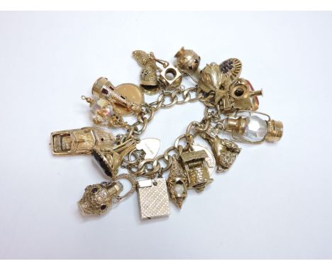 A 9ct gold filed curb link chain bracelet, with padlock clasp, and nineteen assorted charms, including two full sovereigns da