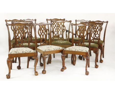 A set of twelve early 20th century Chippendale style dining chairs, comprising two elbow chairs and ten singles, with drop in