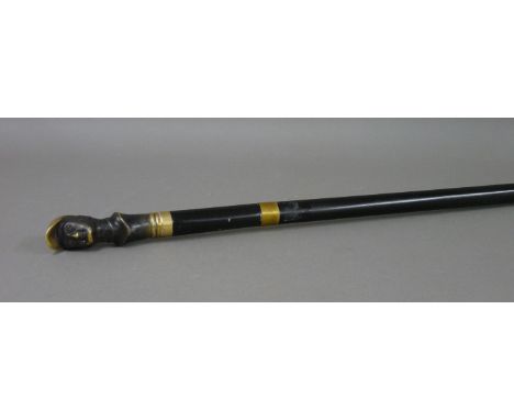 A brass and ebonised jockey head sword stick, 86cm long overall