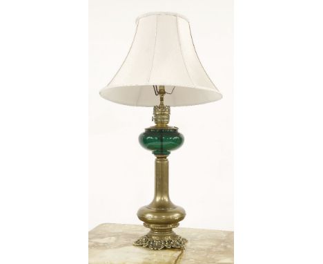 A late Victorian brass oil lamp, with green glass reservoir, and shade, converted, 93cm to top of shade