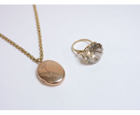 A 9ct gold oval locket, on a 9ct gold rope chain, and a 9ct gold smokey quartz ring