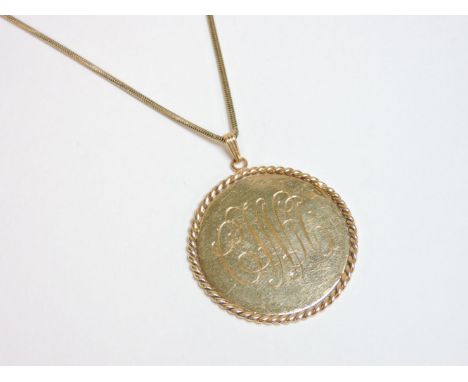 A gold monogram pendant, with presentation inscription marked 14K, on a Brazilian snake chain tested as approximately 14ct go