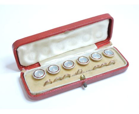 A cased set of six gold mother of pearl and enamel buttons, with split pearl centres and red and white enamel borders, all ma