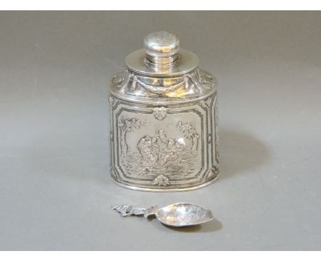 A Dutch silver tea cannister, stamped 800, with panels of figures and putti, 13cm high, and a caddy spoon, with import marks,