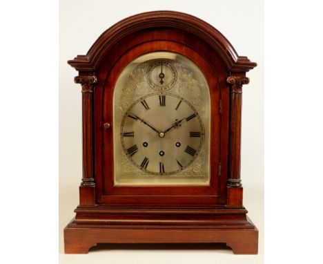 Early 20th century mahogany arched top bracket clock, silvered engraved dial with chime silent, enclosed by fluted columns an