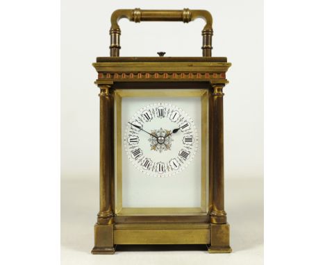Late 19th century brass repeater carriage clock, four turned column supports, dentil cornice, enamel and gilt dial with Roman