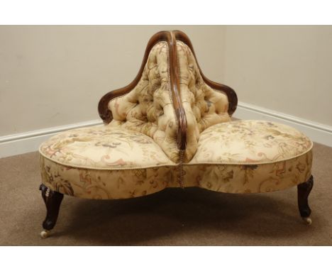 Victorian walnut three seat conversation sofa, three carved scrolled feet with ceramic castors, upholstered in floral urn but