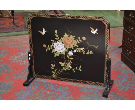 A contemporary black lacquer Oriental fire screen decorated with painted bamboo fronds