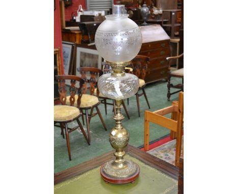 A Victorian oil lamp, brass and clear glass reservoir, etched shade