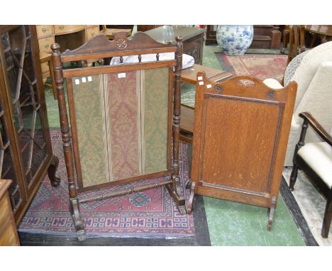 A Victorian oak firescreen, turned supports, c1880; a 20th century oak carved firescreen 