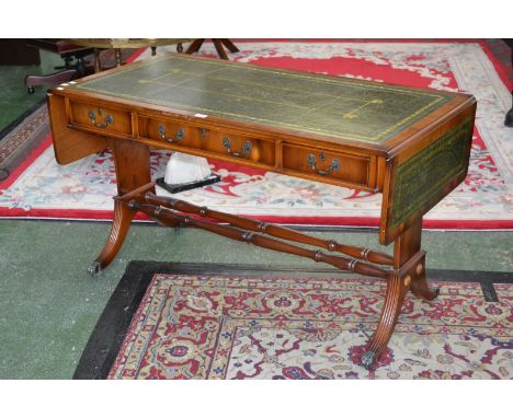 A Regency reproduction yew wood sofa table, tooled leather inlay, three cockbeaded drawers to frieze, turned stretchers, reed