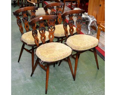 A set of four bow back Ercol dining chairs