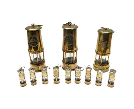 Three brass miner's safety lamps by ECCLES The Protector Lamp & Lighting Co. Ltd., height 23cm., together with nine miniature