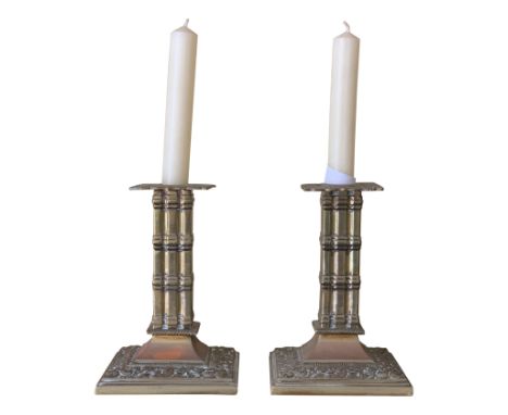 A pair of Victorian brass cluster column square section candlesticks.From the estate of Ashley Barker OBE who was born in Her