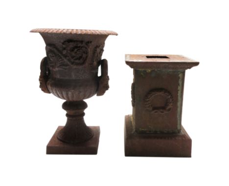 A cast iron twin handled garden urn, on pedestal stand, height 71cm overall. From the estate of Ashley Barker OBE who was bor