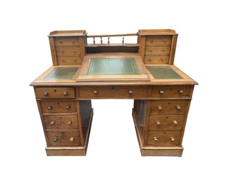 A Victorian light oak twin pedestal desk, the back with a pair of three drawer miniature Wellington chest, between these a co