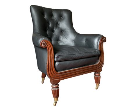 A Regency buttoned black leather upholstered library chair, the front legs turned, fluted mahogany. From the estate of Ashley