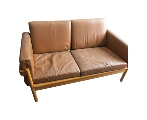 A mid century H.W.Klein oak two seater sofa, with brown leather cushions, height 69cm, width 133cm.