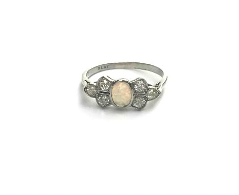 A 1930s platinum diamond and opal ring set to represent a bow.