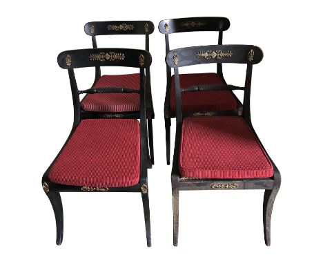 A set of four Regency ebonised brass mounted sabre leg dining chairs.From the estate of Ashley Barker OBE who was born in Her