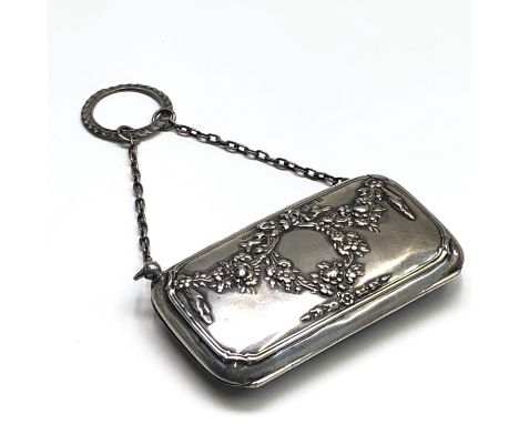 An Edwardian embossed silver visiting card purse with silver chain and finger ring.