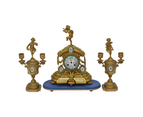 A French gilt metal and porcelain clock garniture, late 19th century, each piece mounted with a musical putti, the clock with