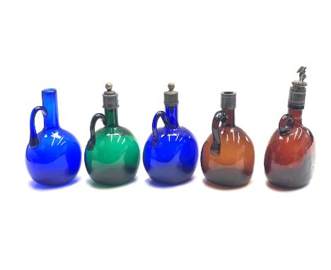 A collection of four early 20th century coloured glass and metal mounted spirit flasks, the tallest 24.5cm, and one later spi