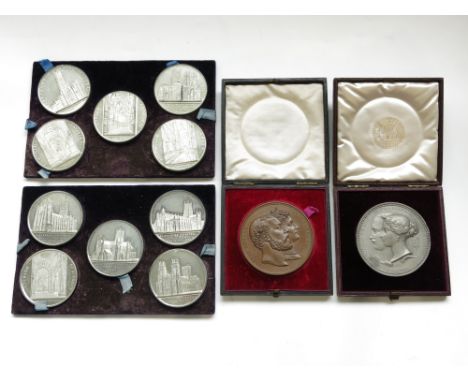 A collection of twenty-four 19th century architectural and commemorative medals in silver, white metal and bronze.From the es