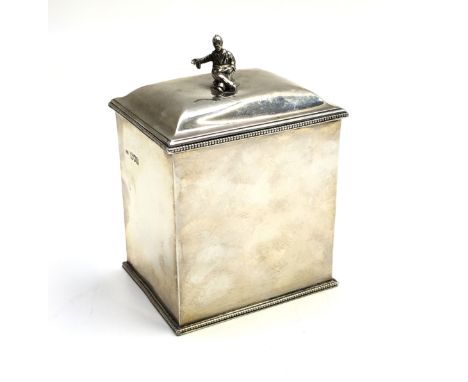 A silver square section tea caddy with beaded foot and rim, the domed lid with a seated Oriental figure finial, makers marks 