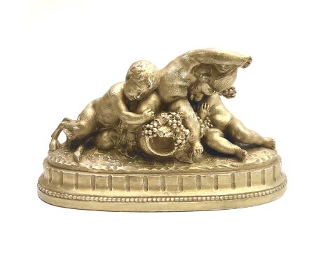 A ceramic table centre with gilded decoration, in the form of a satyr and two cherubs seated on a large amphora, signed Calen