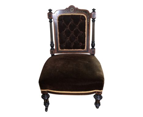 A high Victorian side chair ebonised parcel gilt and maple veneers the back with a buttoned upholstered panel.From the estate