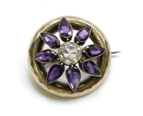 A 9ct gold amethyst and white stone set brooch.