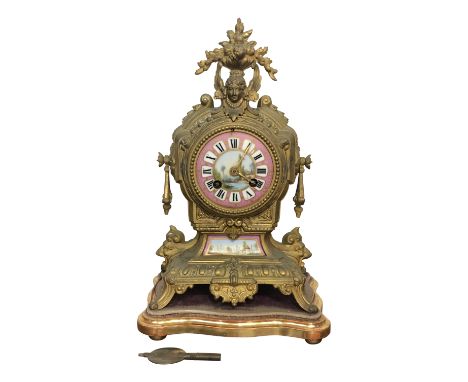 A French gilt metal mantel clock, late 19th century, of Classical form with Paris porcelain dial and plaque, painted landscap