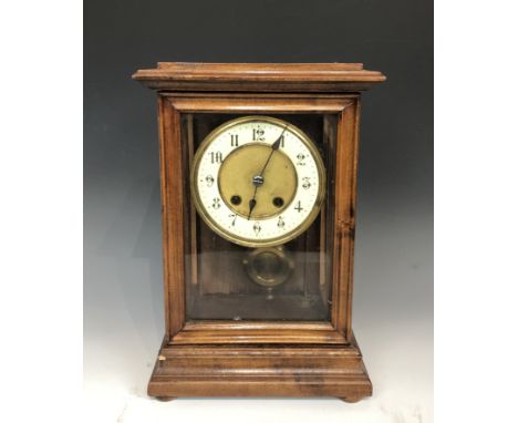A decorative mantle clock with a cream enamel dial, in a carved stained wood case, height 29cm, width 20cm, depth 14cm.