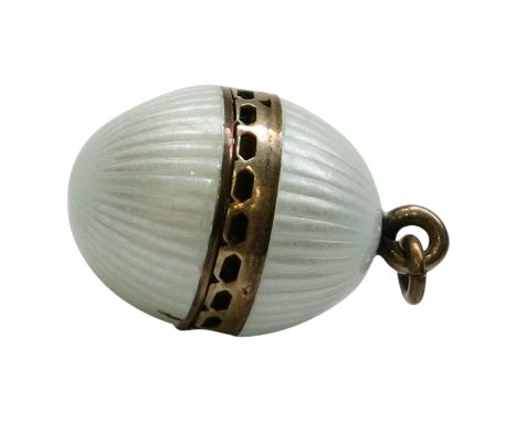 A late 19th or early 20th century continental silver gilt vinaigrette in the form of an egg, the two halves with opalescent e