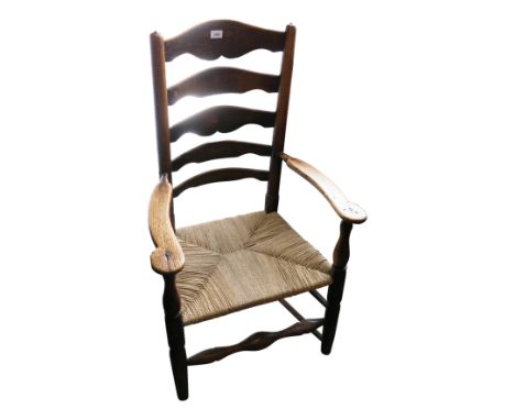 An ash and elm ladder-back chair, with reeded rush seat, height 94cm.