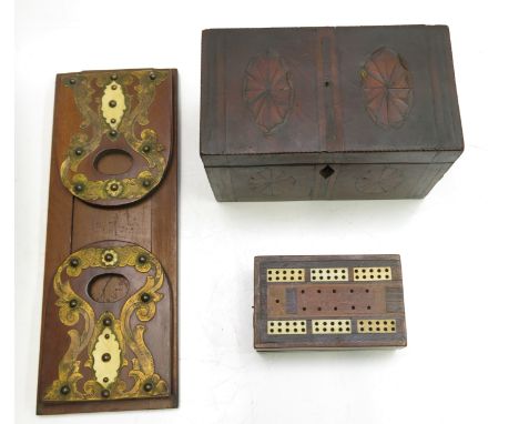 A Victorian brass bound mahogany book slide, a George III inlaid mahogany tea caddy and an inlaid mahogany Cribbage board. 
