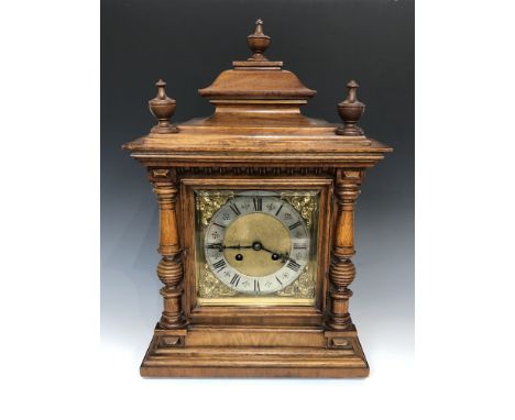 A mahogany mantel clock, circa 1900, the case surmounted by three turned finials, height 46cm, width 29cm.