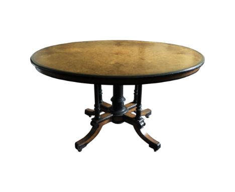 A fine Gillows late Victorian centre table, veneered with birds eye maple, ebonised parcel gilt and shallow carved, the oval 