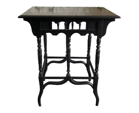A good high Victorian ebonised occasional table in the manner of Godwin, the frieze with simple stylised incise flower heads 