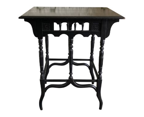 A good high Victorian ebonised occasional table in the manner of Godwin, the frieze with simple stylised incise flower heads 