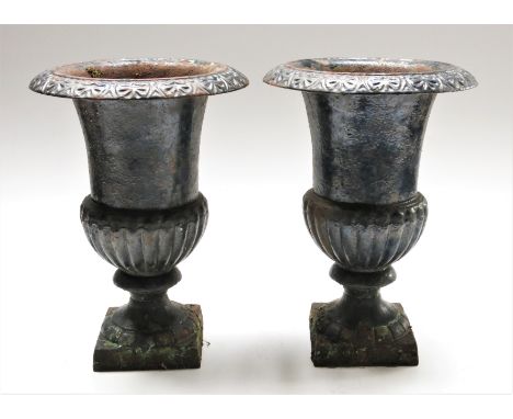 A pair of black painted cast metal garden urns, height 35.5cm.From the estate of Ashley Barker OBE who was born in Hertfordsh
